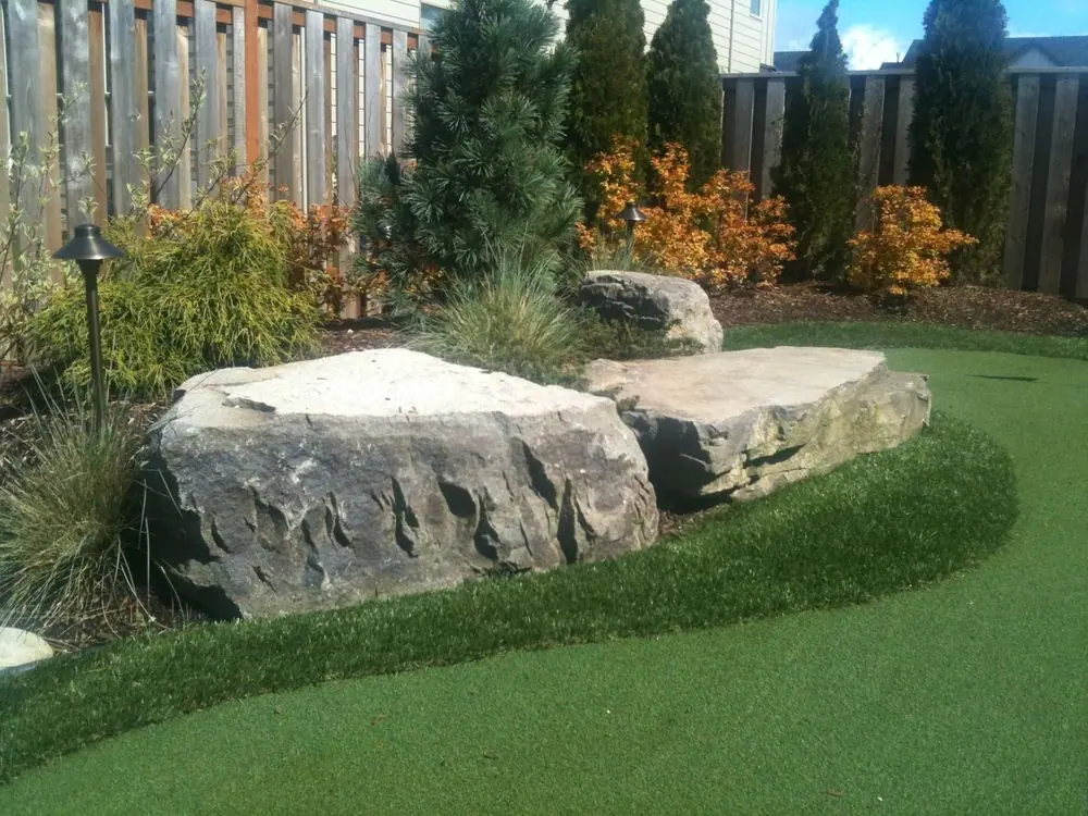 Boulders placed as benches around putting green